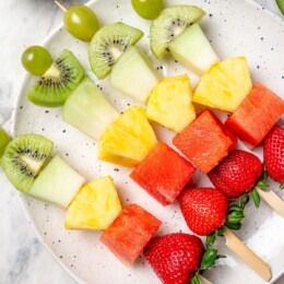 Overhead view of fruit kabobs on platter