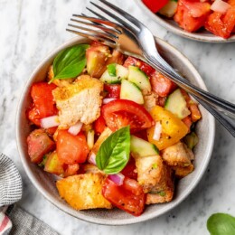 Overhead view of panzanella in bowl with two forks