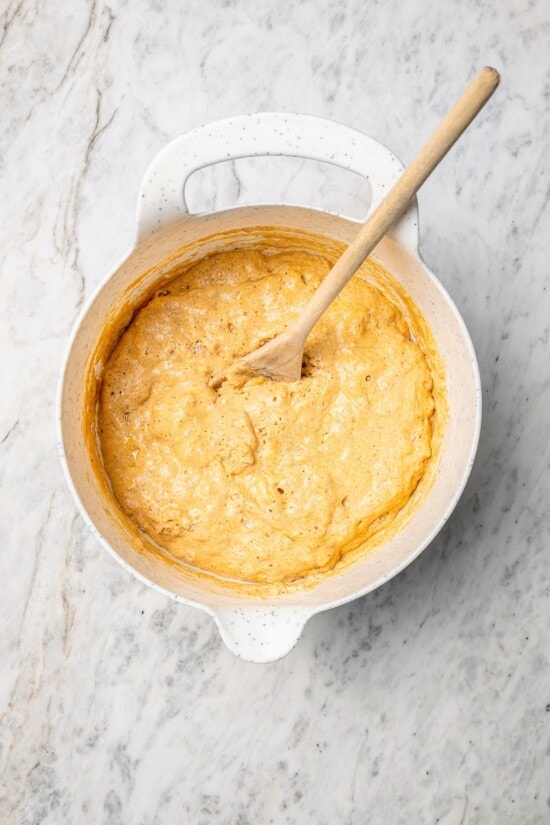 This lightened up version of pumpkin pancakes is also extra fluffy! You'll love the cozy fall flavor in this easy, healthier pancake recipe. Overhead view of batter for pumpkin pancakes