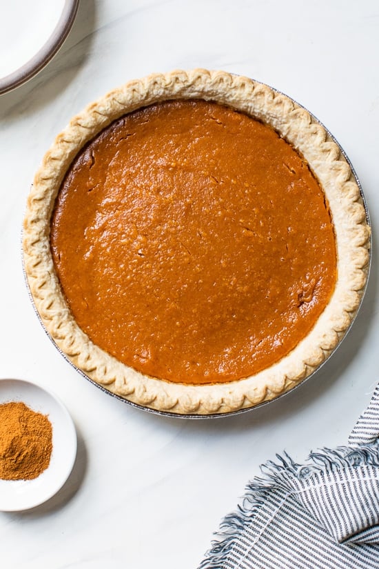 Still looking for the perfect Thanksgiving dessert? This easy, healthier version of the classic sweet potato pie recipe is always a hit! Whole sweet potato pie in pan