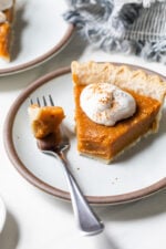 Sweet potato pie slice on plate, with tip on fork