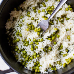 This simple Baked Rice and Peas dish uses pantry and freezer staples, a great side dish to go along with grilled shrimp or chicken.