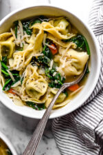 Spinach Tortellini en Brodo (in broth) is an Italian soup made with spinach and cheese tortellini and vegetables in a light broth.