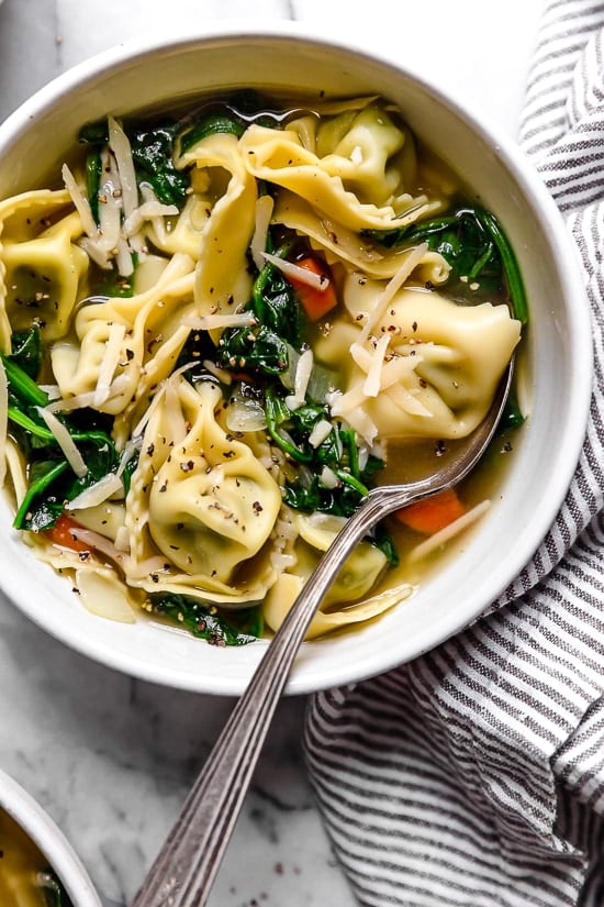Spinach Tortellini en Brodo (in broth) is an Italian soup made with spinach and cheese tortellini and vegetables in a light broth.