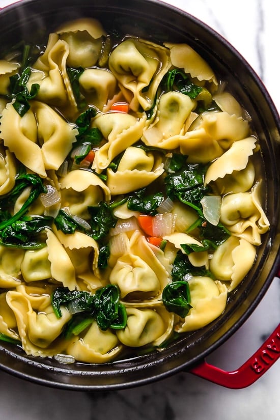 Spinach Tortellini en Brodo (in broth) is an Italian soup made with spinach and cheese tortellini and vegetables in a light broth.