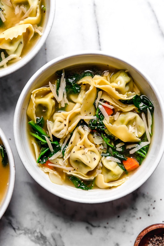 Spinach Tortellini en Brodo (in broth) is an Italian soup made with spinach and cheese tortellini and vegetables in a light broth.