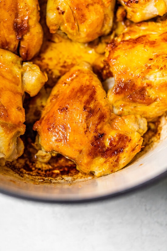 Authentic Arroz Con Pollo, or Latin chicken and rice, is the ultimate one-pot meal. It’s a classic Latin dish that I grew up with and love! Browned chicken for arroz con pollo in a Dutch oven.