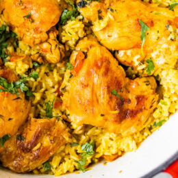 Overhead view of Arroz Con Pollo in a red Dutch oven.