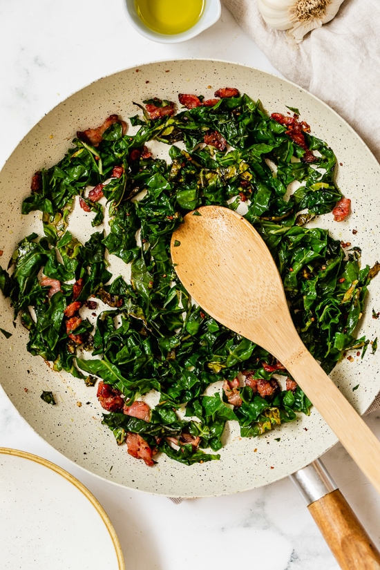Collard Greens and Bacon in a skillet.