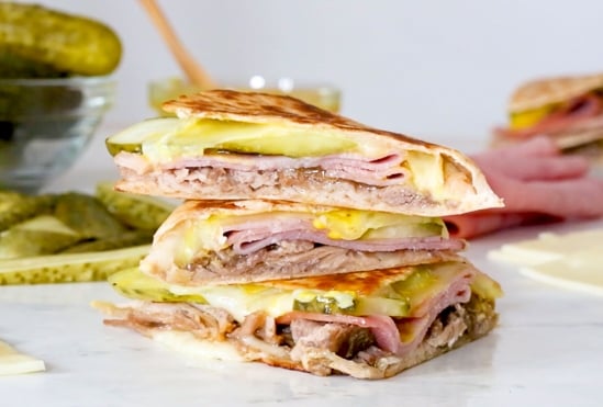 I made my favorite Cuban sandwich into a quesadilla filled with roast pork (pernil), ham, Swiss cheese, pickles, and mustard! Perfect for a quick lunch and a great way to use up my Slow Cooker Pernil.
