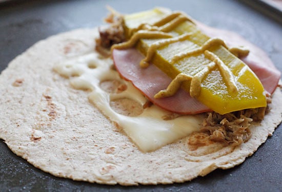 I made my favorite Cuban sandwich into a quesadilla filled with roast pork (pernil), ham, Swiss cheese, pickles, and mustard! Perfect for a quick lunch and a great way to use up my Slow Cooker Pernil.