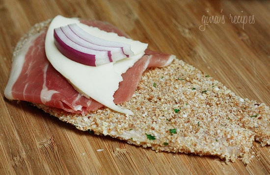 Chicken cutlets dipped in lemon and olive oil, gently coated in a combination of bread crumbs and romano cheese then rolled with prosciutto, cheese and red onion and baked until golden.
