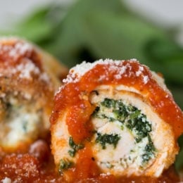 Chicken Rollatini with Spinach alla Parmigiana is Italian comfort food at it's finest! Made with breaded chicken breasts filled and rolled with spinach and cheese topped with sauce and melted mozzarella.