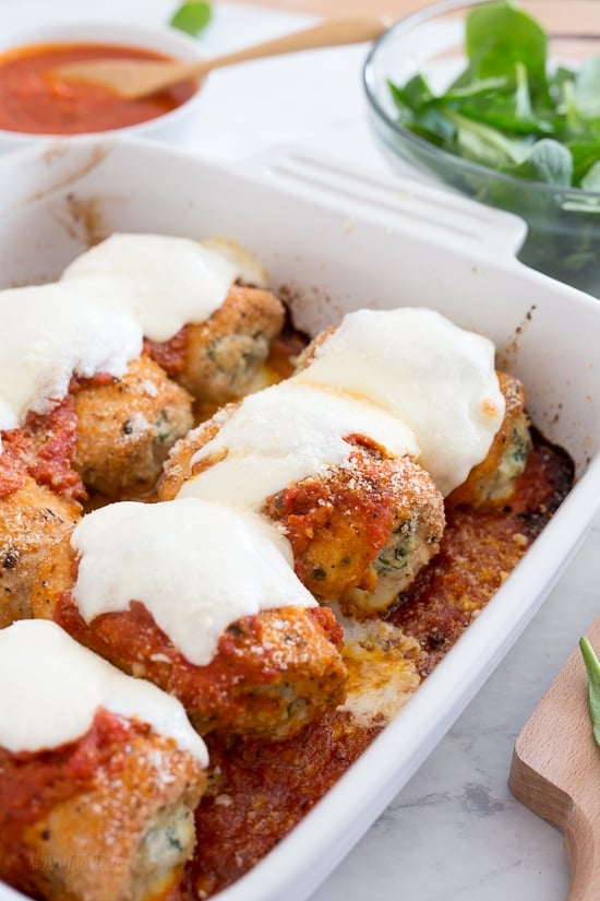 Chicken Rollatini with Spinach alla Parmigiana is Italian comfort food at it's finest! Made with breaded chicken breasts filled and rolled with spinach and cheese topped with sauce and melted mozzarella.
