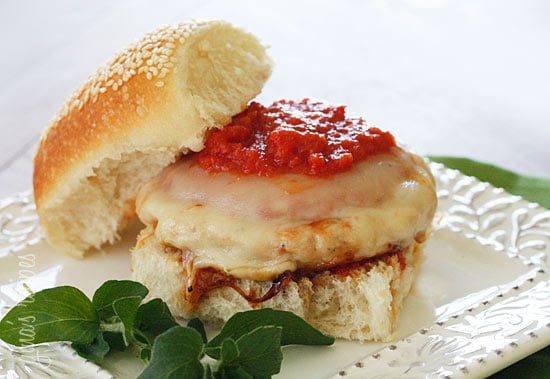 A chicken parm burger on a white plate
