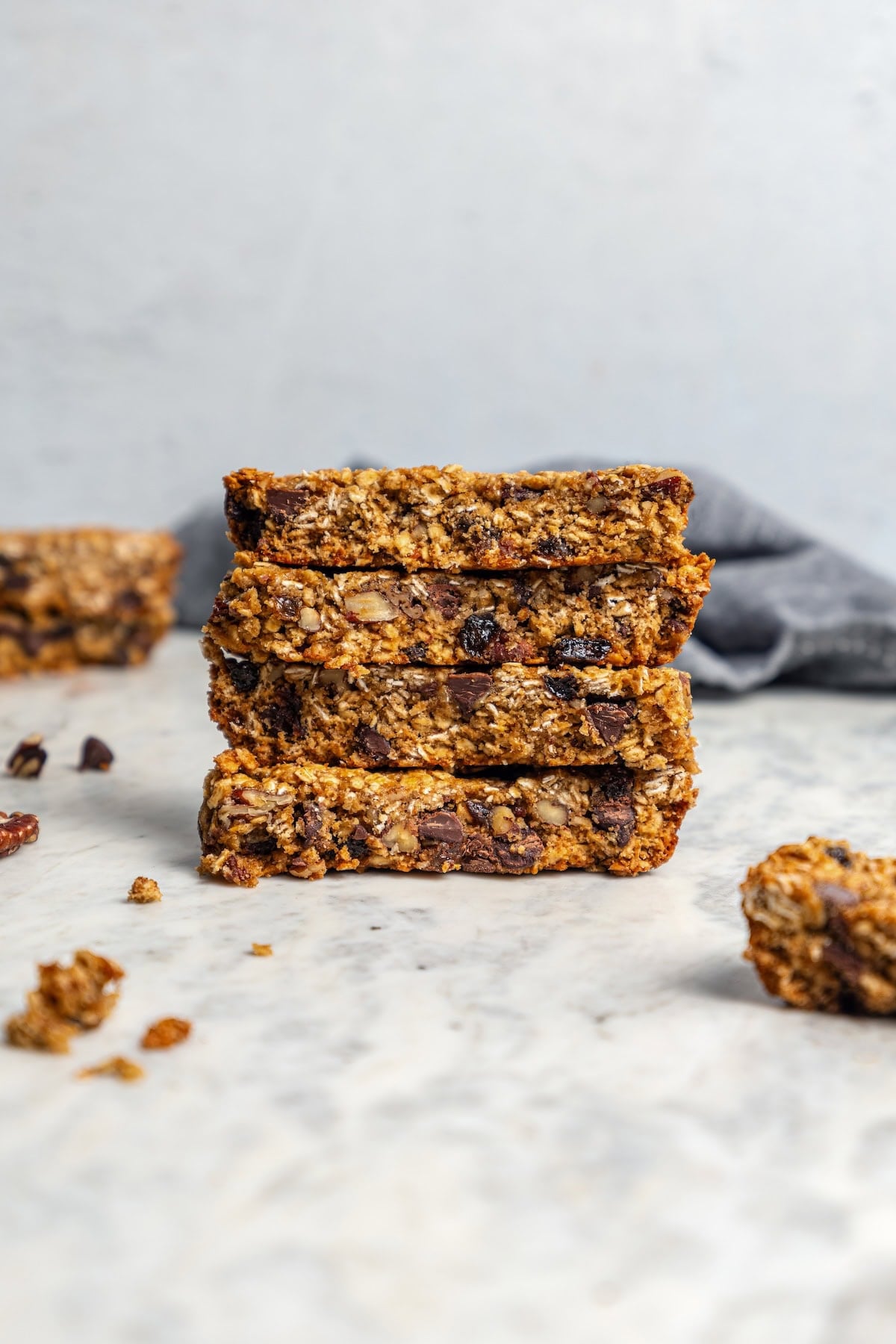 Chewy granola bars are so easy to make at home! This recipe is lighter than other versions and can be customized with your favorite mix-ins. Stack of 4 healthy chewy granola bars on countertop.