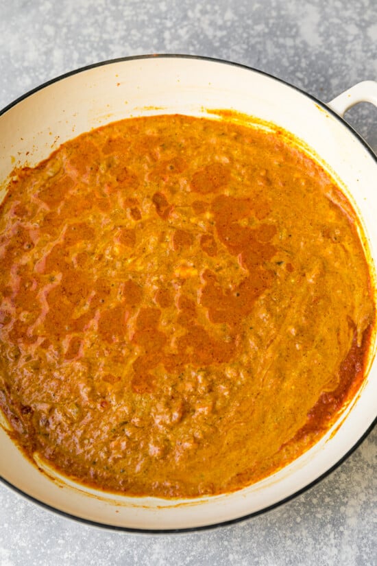 Simmer sauce and temper the yogurt.