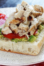 An open faced sandwich on Ciabatta bread with mashed avocado, sliced tomatoes and grilled chicken. A perfect way to use up leftover chicken.