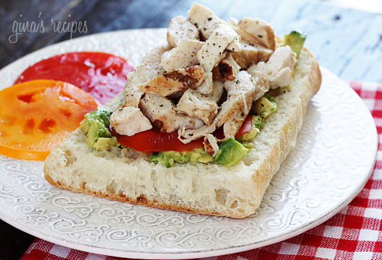 An open faced sandwich on Ciabatta bread with mashed avocado, sliced tomatoes and grilled chicken. A perfect way to use up leftover chicken.