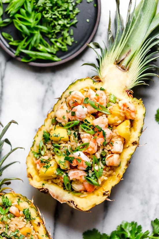 Pineapple Shrimp Fried Rice has a delicious flavor combination of savory, sweet and spicy. Serve it in hollowed out pineapples for a beautiful presentation!