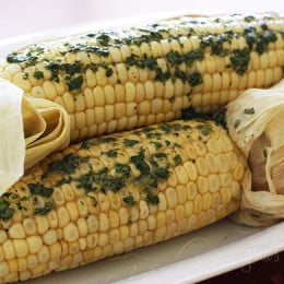 Sweet summer corn roasted in the oven and topped of with a light compound butter using fresh cilantro and a pinch of chipotle pepper and cumin.