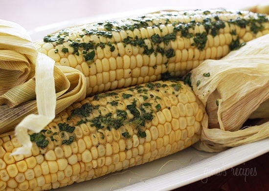 Sweet summer corn roasted in the oven and topped of with a light compound butter using fresh cilantro and a pinch of chipotle pepper and cumin.
