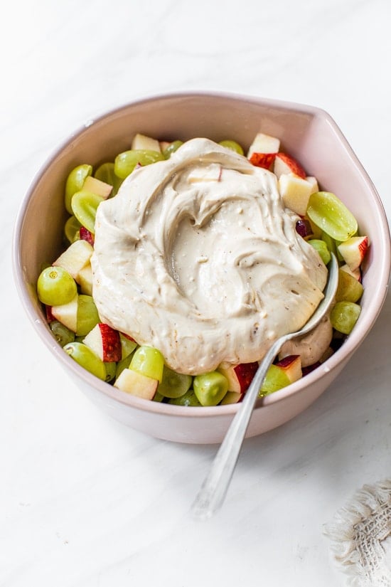 bowl with apples, grapes, yogurt and cream cheese