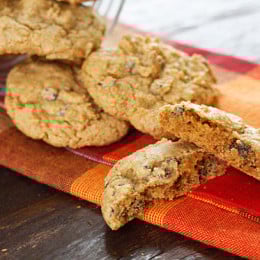 A fabulous Fall pumpkin spiced chocolate chip cookie! This is what happens when you take the Best Low Fat Chocolate Chip Cookie Recipe and swap out the apple sauce for pumpkin puree, then add lots of pumpkin pie spice!