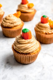 Cake mix pumpkin cupcakes with cream cheese frosting and pumpkin candies on top