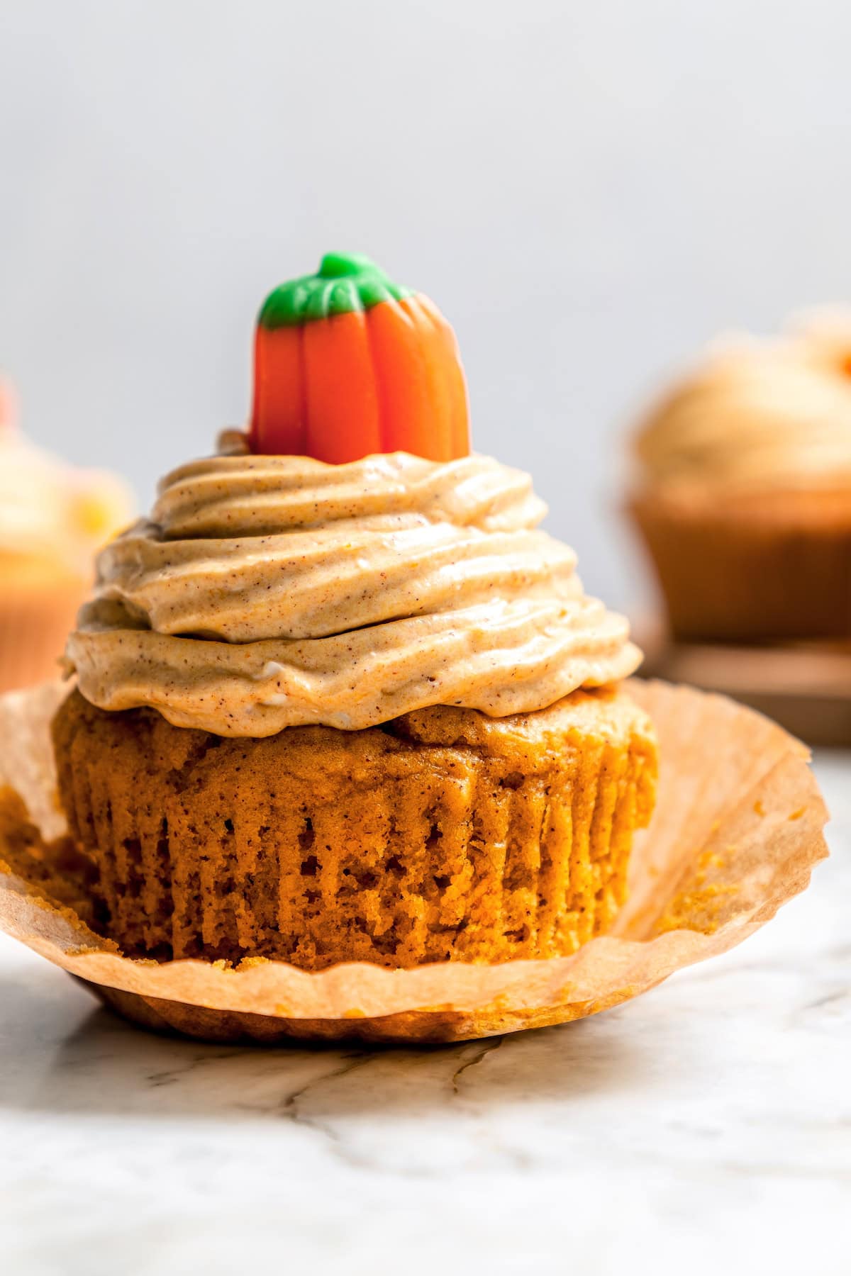Boxed cake mix makes these pumpkin cupcakes easy to whip up for Halloween parties, Thanksgiving or anytime you want a cozy fall treat! Moist pumpkin cupcake with pumpkin cream cheese frosting