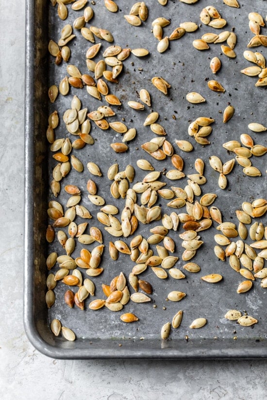 roasted pumpkin seeds on a baking sheet