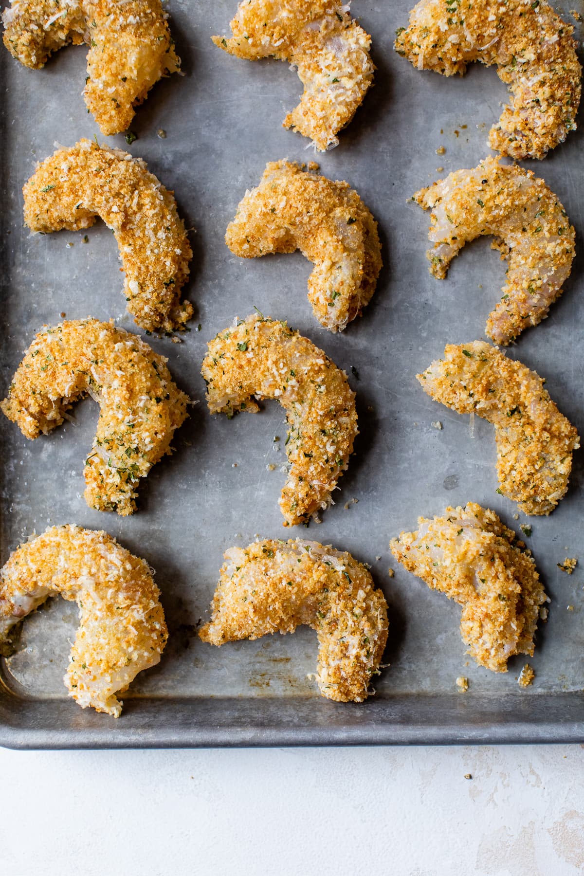 Baked breaded shrimp on a sheet pan