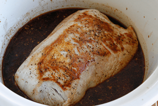 Boneless pork roast slow cooked in Asian spices creates a aromatic pork dish with mushrooms and broth, perfect over noodles or rice with fresh chopped green onions, cilantro and sriracha.