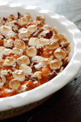 A sweet potato casserole with marshmallows in a round baking dish.
