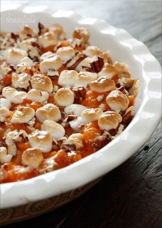 A sweet potato casserole with marshmallows in a round baking dish.