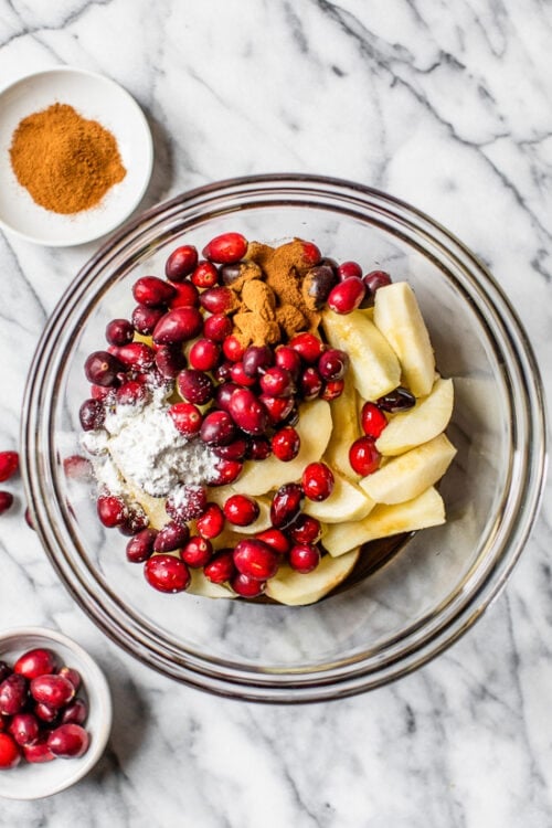 apples and cranberries in a bowl