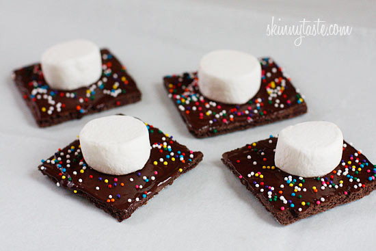 Smores Pops – Chocolate graham crackers coated with melted chocolate and marshmallows on a stick. A fabulous winter treat whether you want to make them as favors or just have fun making them with the kids.