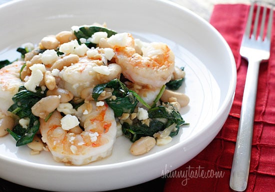 Shrimp, white beans and wilted spinach topped with crumbled feta. Perfect for a weeknight meal, this dish is delicious and super easy to make!