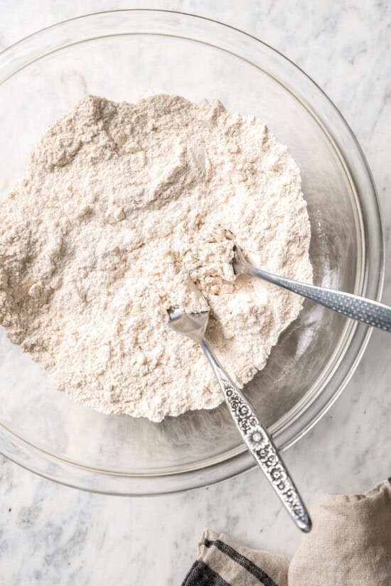 Chocolate chip scones are sweetened to perfection and studded with chocolate chips to make them taste like a treat. An easy no-fail recipe! Working butter into dry ingredients for scones with 2 forks