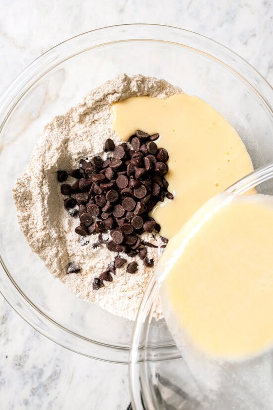 Chocolate chip scones are sweetened to perfection and studded with chocolate chips to make them taste like a treat. An easy no-fail recipe! Pouring liquid into dry ingredients for scones