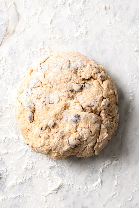 Chocolate chip scones are sweetened to perfection and studded with chocolate chips to make them taste like a treat. An easy no-fail recipe! Overhead view of dough for chocolate chip scones