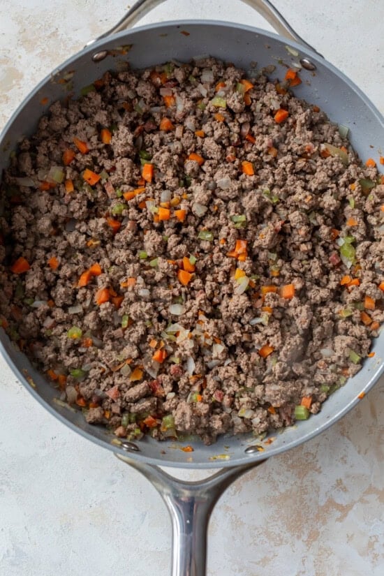 Brown the beef in a skillet.