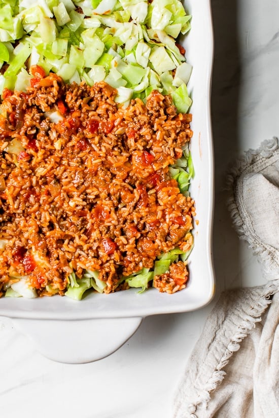 This Stuffed Cabbage Casserole is basically a deconstructed version of stuffed cabbage layered with shredded cabbage, ground beef and brown rice cooked in tomatoes then topped with melted cheese. It's SO good!