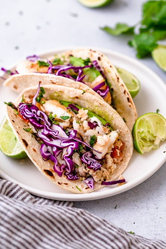 These easy Cilantro Lime Fish Tacos are made with flaky white fish, tomatoes, jalapeños, cilantro and lime topped with avocado.
