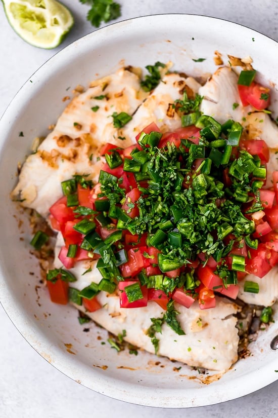 These easy Cilantro Lime Fish Tacos are made with flaky white fish, tomatoes, jalapeños, cilantro and lime topped with avocado.