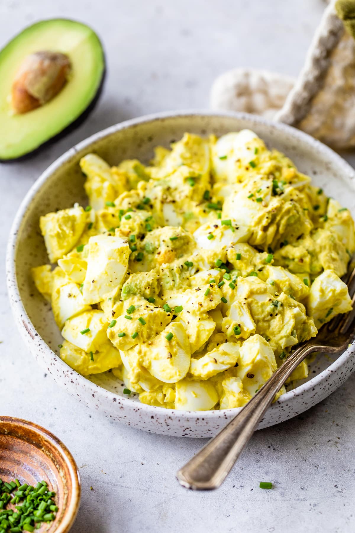 This avocado egg salad uses half the egg yolks and adds lots of healthy fats from avocado. An easy healthy, high protein lunch! Avocado Egg Salad in a bowl.