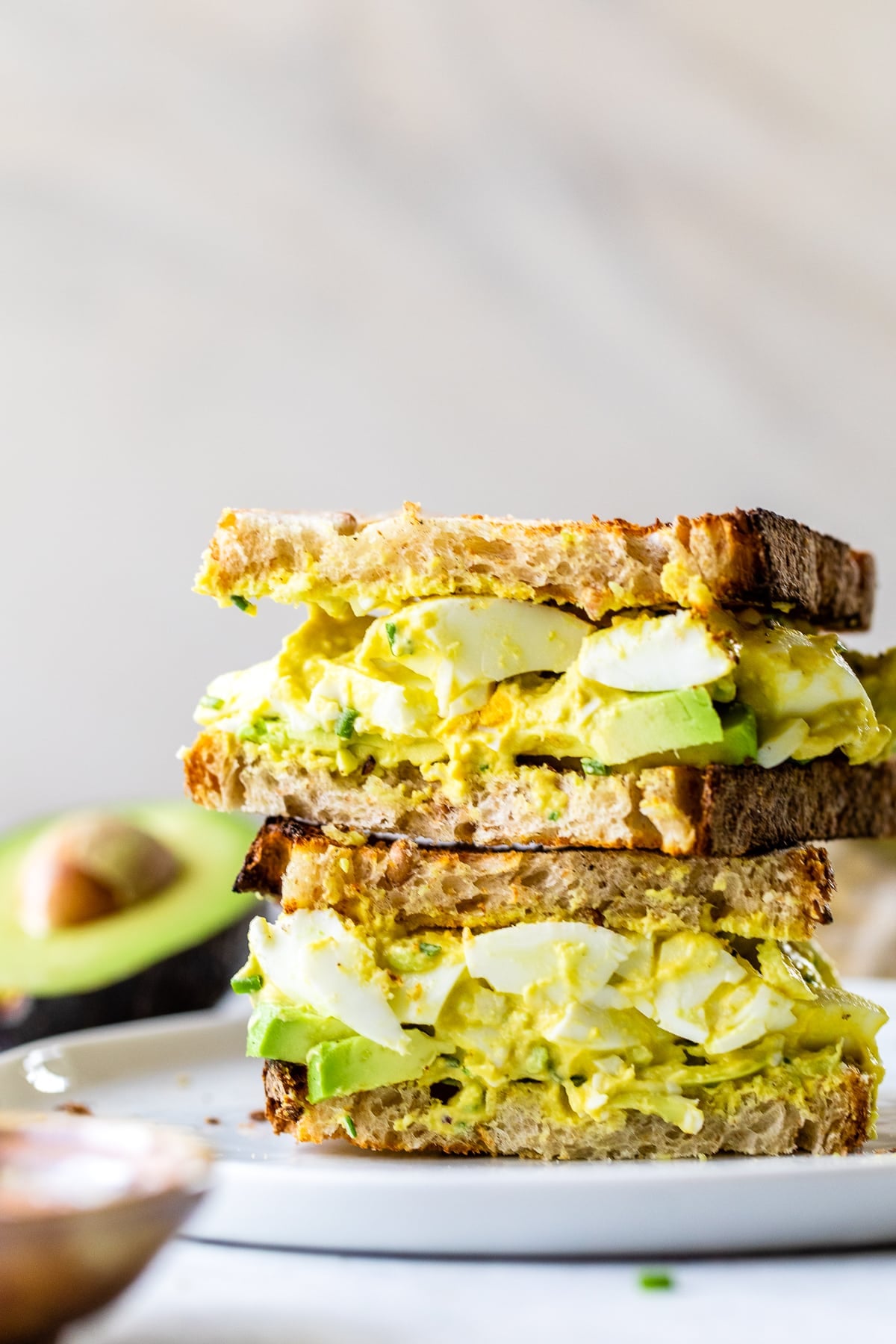 Avocado Egg Salad sandwich cut in half.