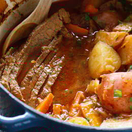 Braised Brisket with Potatoes and Carrots in dutch oven.