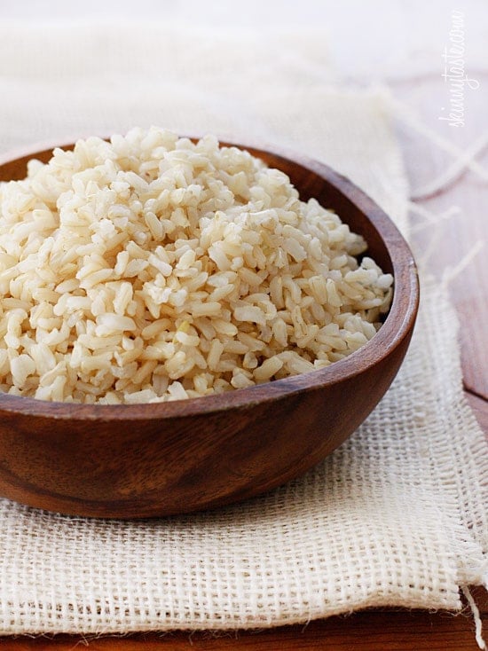 Want to know how to cook perfect brown rice? This easy, foolproof brown rice recipe will give you perfect rice that is never sticky. A bowl filled with cooked brown rice.