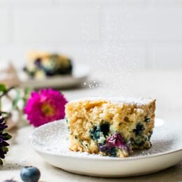A slice of Blueberry Buttermilk Cake on a plate.